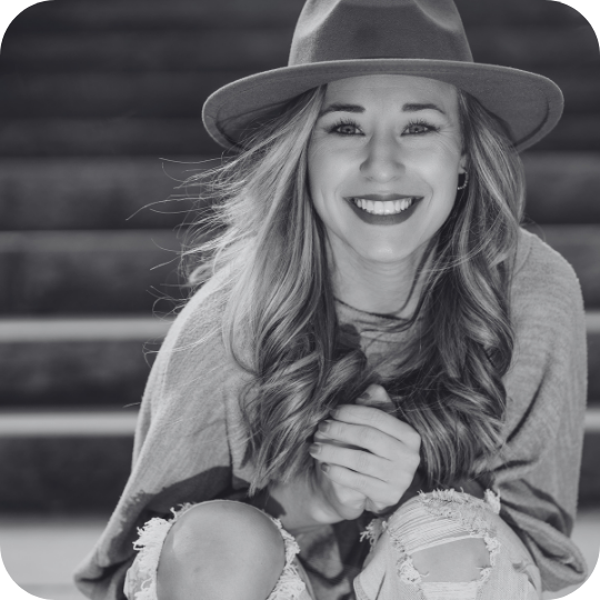 Black and white photo of a young woman looking confidently at the camera.
