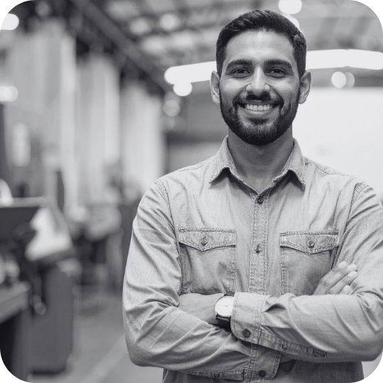 Black and white photo of a man with beard looking confidently at the camera.