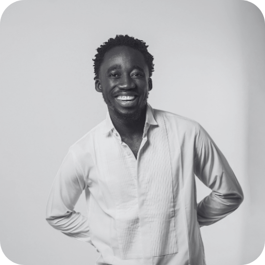 Black and white photo of a man looking confidently at the camera.